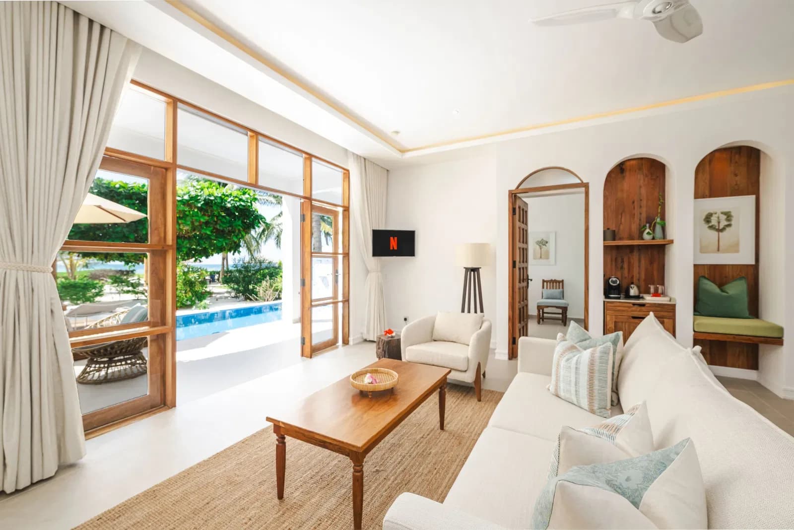 Villa living room opening onto a private pool deck at Kisiwa on the Beach, Zanzibar