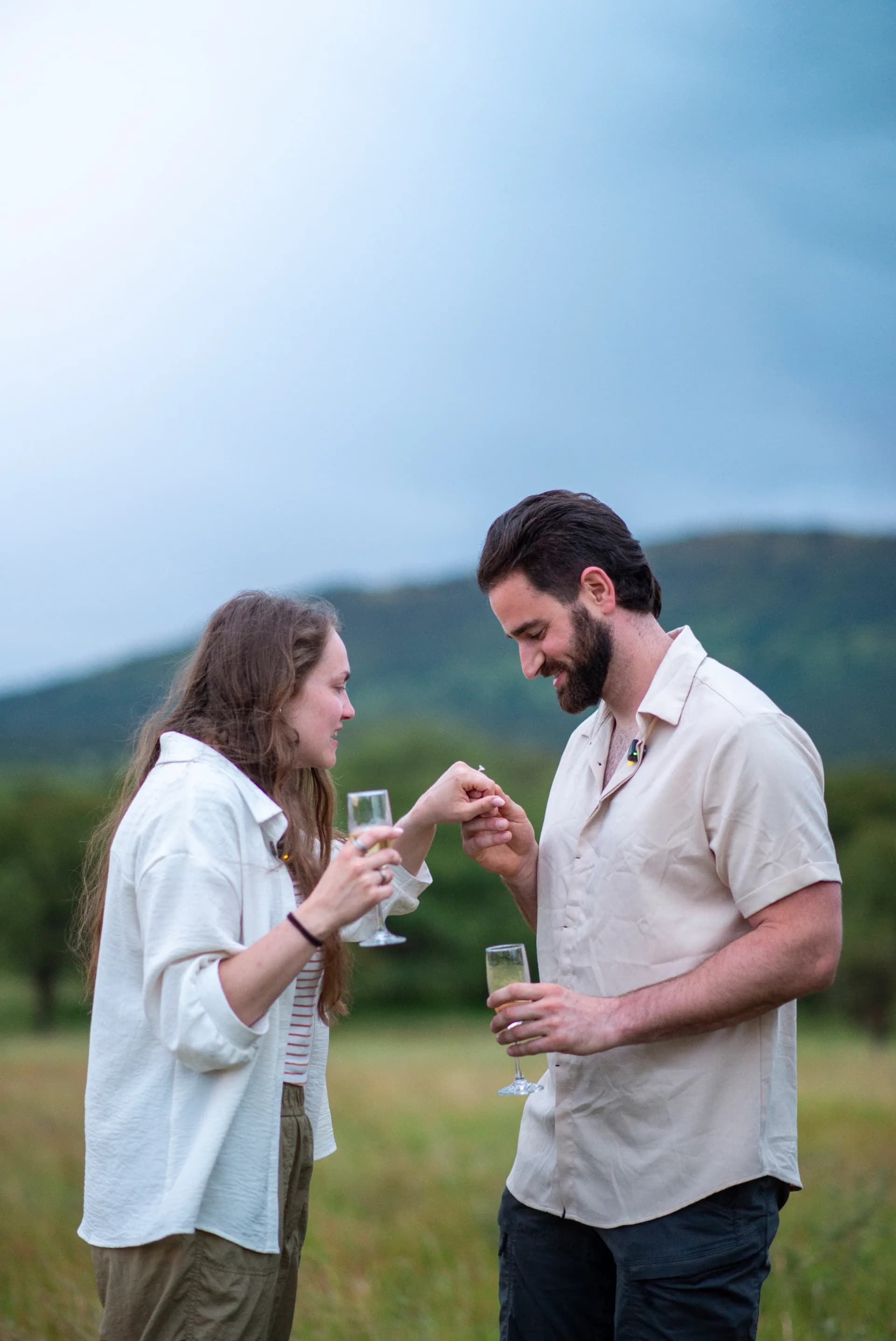 A couple sharing a champagne toast together on the Serengeti plains
