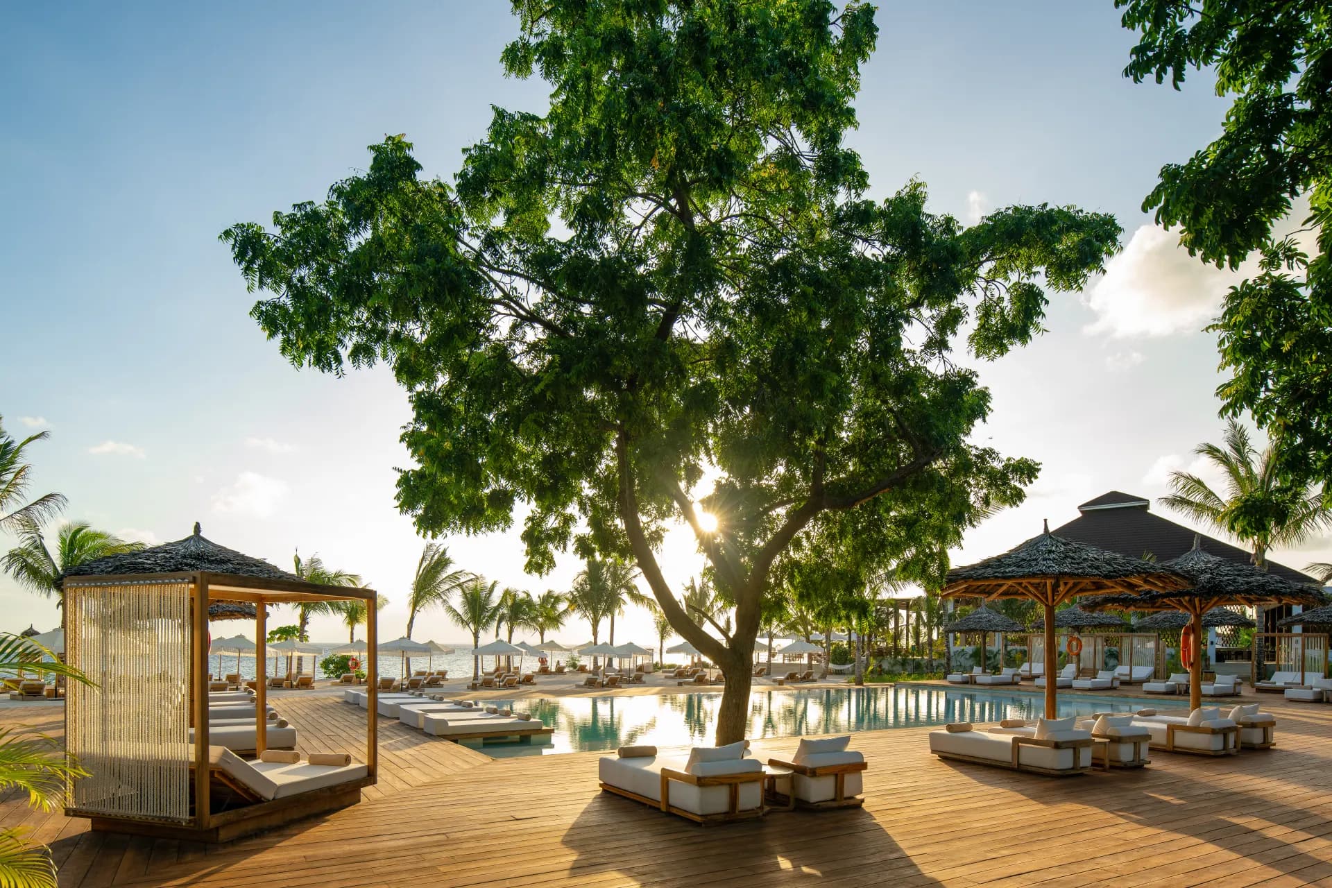 Beachfront view of a Zanzibar resort property, with loungers set along the white sand